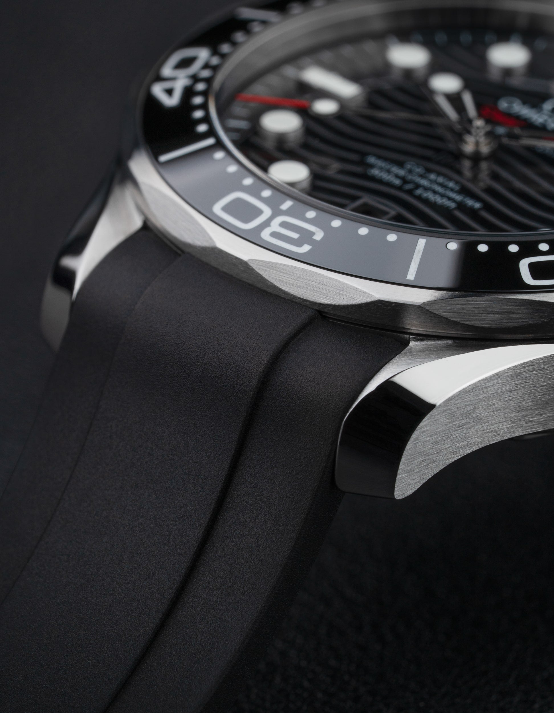Black Rubber Strap on an Omega Seamaster with dark background.