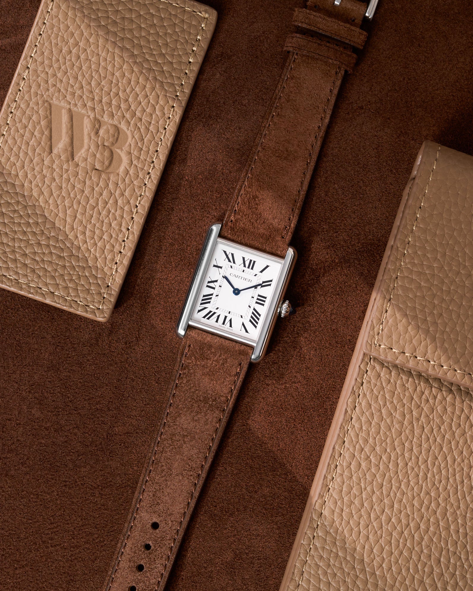 Cartier Tank Must Large featuring brown Suede leather strap, watch facing up on table surface