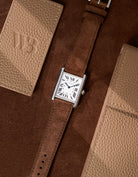 Cartier Tank Must Large featuring brown Suede leather strap, watch facing up on table surface