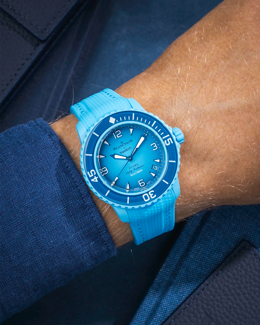 Blue lagoon Rubber Strap on Blancpain X Swatch Blue Lagoon, wrist shot styled with a shirt