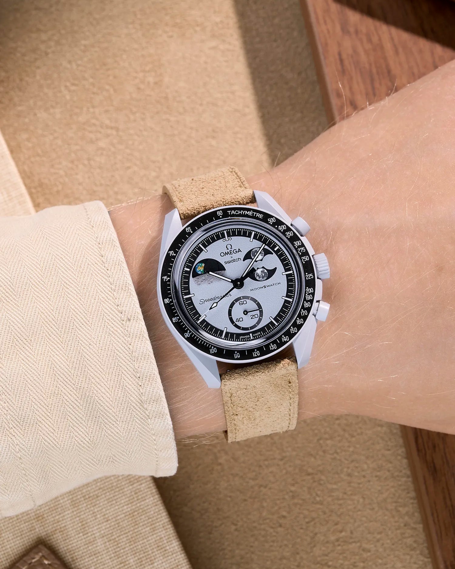 Omega X Swatch Mission to Earthphase with beige suede leather strap worn on wrist