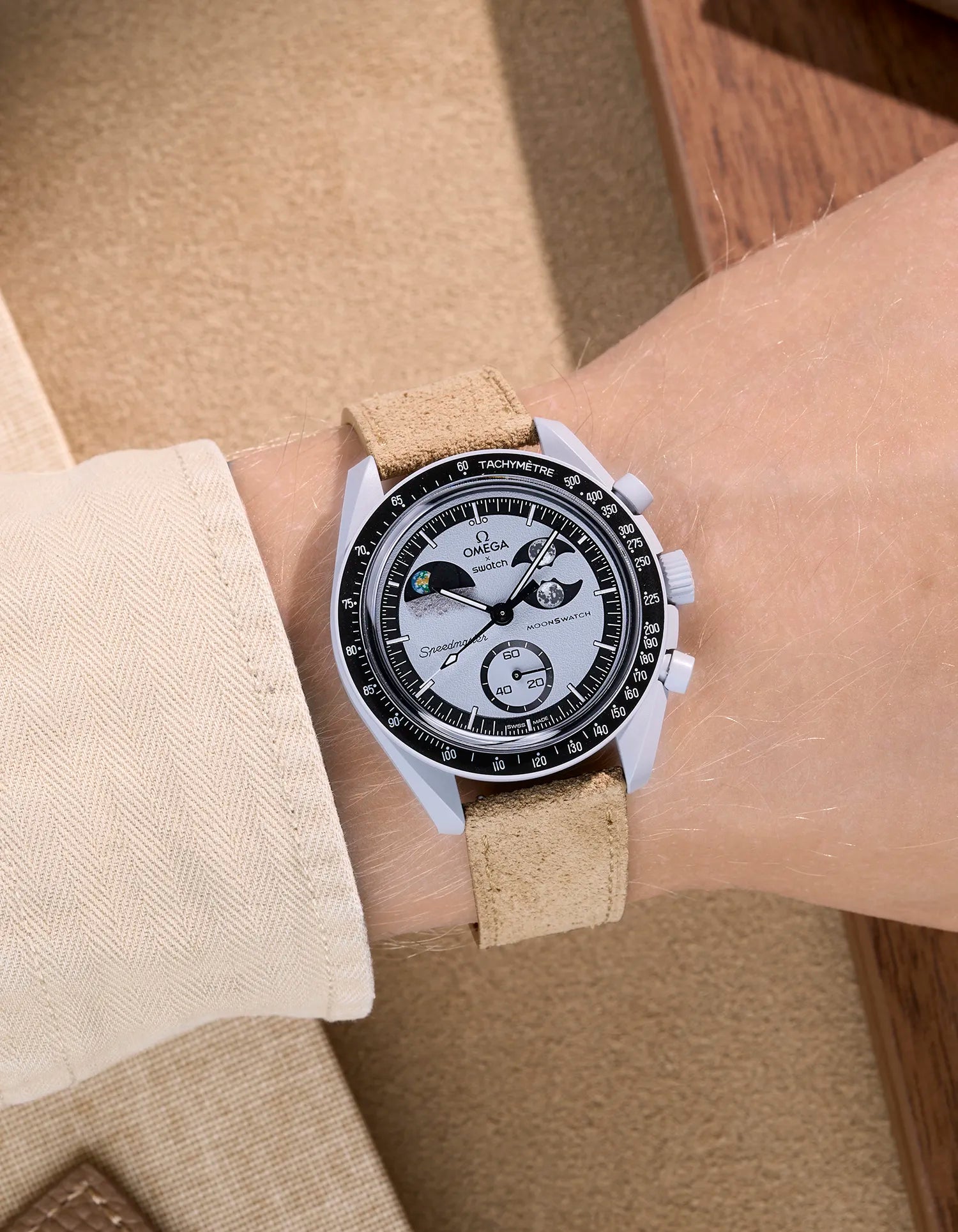 Omega X Swatch Mission to Earthphase with beige suede leather strap worn on wrist