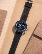 Flat lay Moonswatch Mission to the Moon with Black suede leather strap