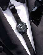 Flat lay Moonswatch Mission to the Moonphase New Moon with Black suede leather strap