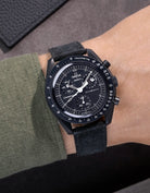 Omega X Swatch Mission to the Moonphase New Moon with black suede leather strap worn on wrist