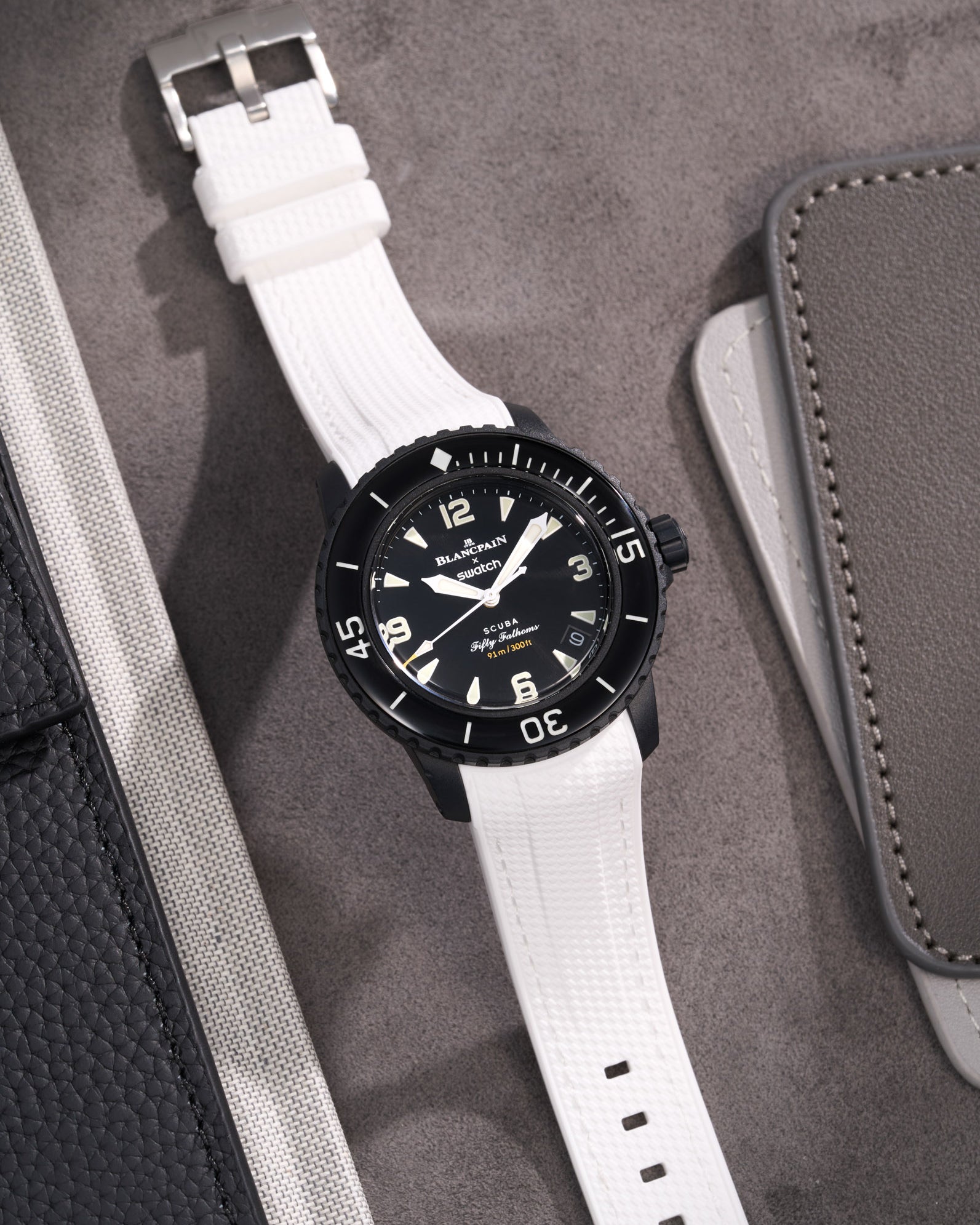 Blancpain X Swatch watch featuring white Vertech rubber strap elegant flat lay product image on grey surface