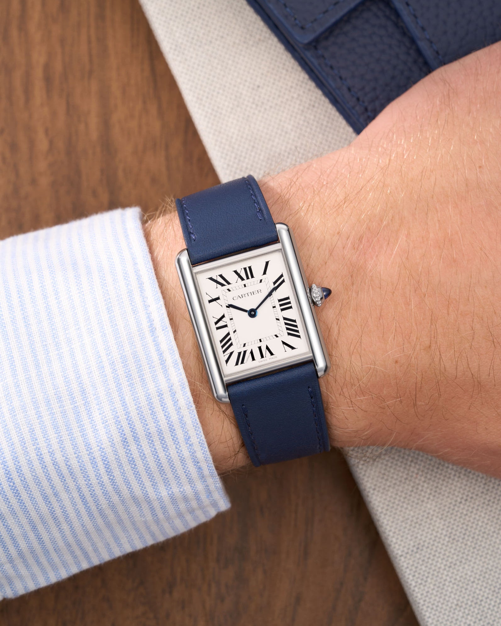 Navy Blue Cowhide Leather Straps for Cartier Tank Must Large wrist shot with a white and blue shirt over a table