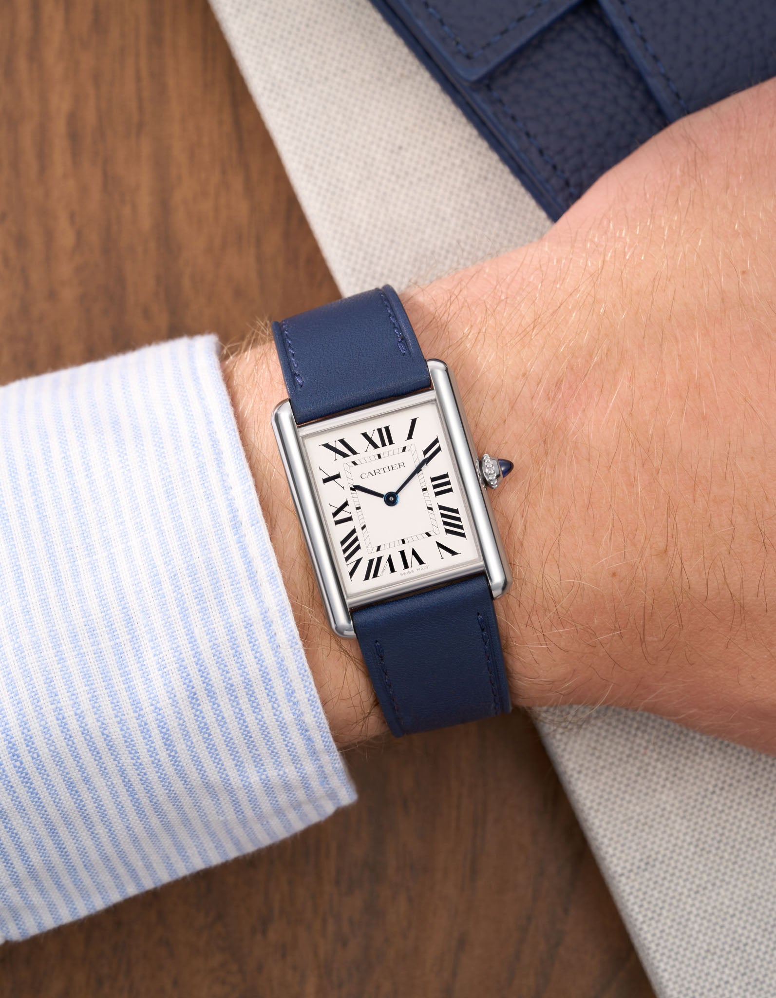 Navy Blue Cowhide Leather Straps for Cartier Tank Must Large wrist shot with a white and blue shirt over a table