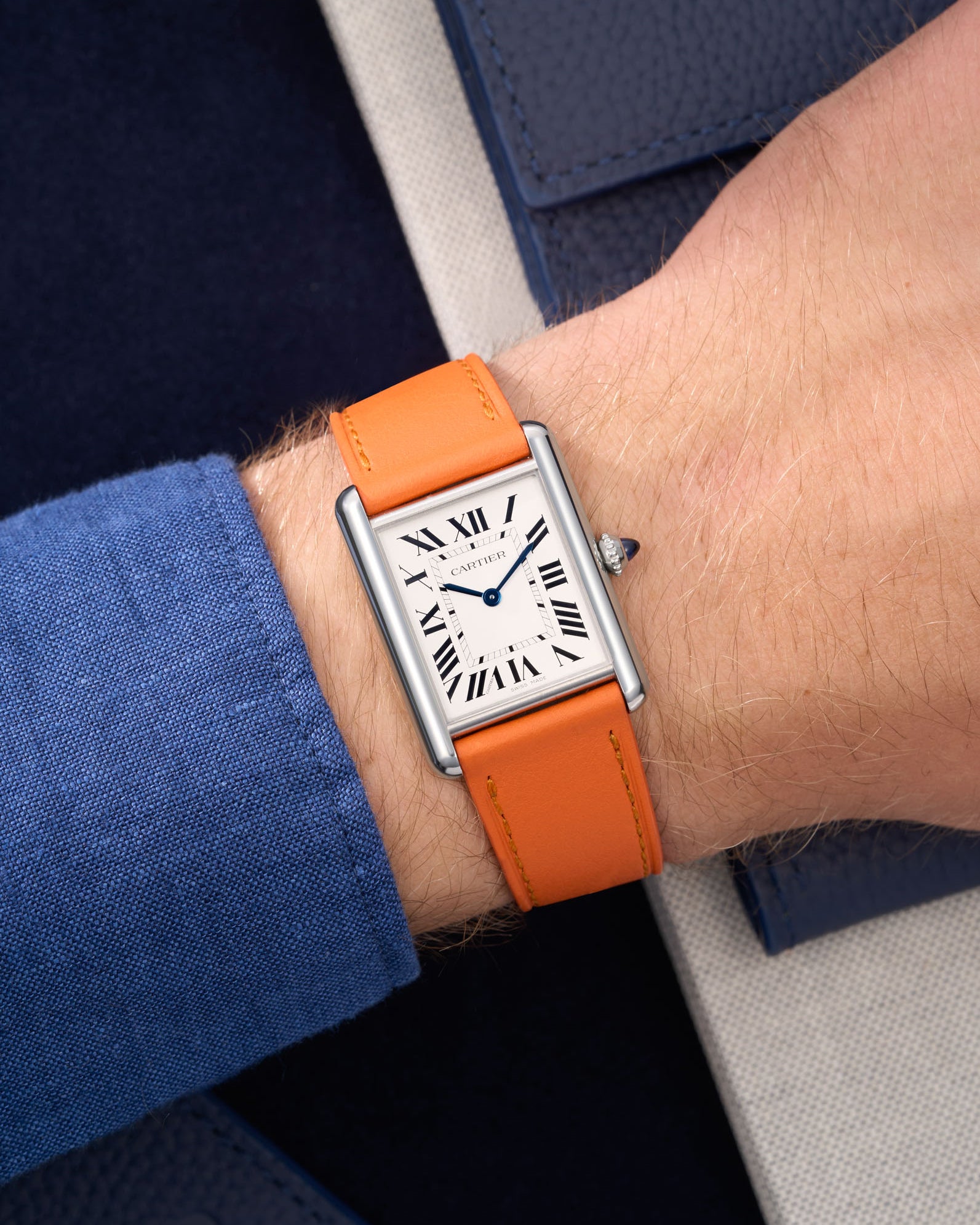 Orange Cowhide Leather Straps for Cartier Tank Must Large wrist shot over blue table