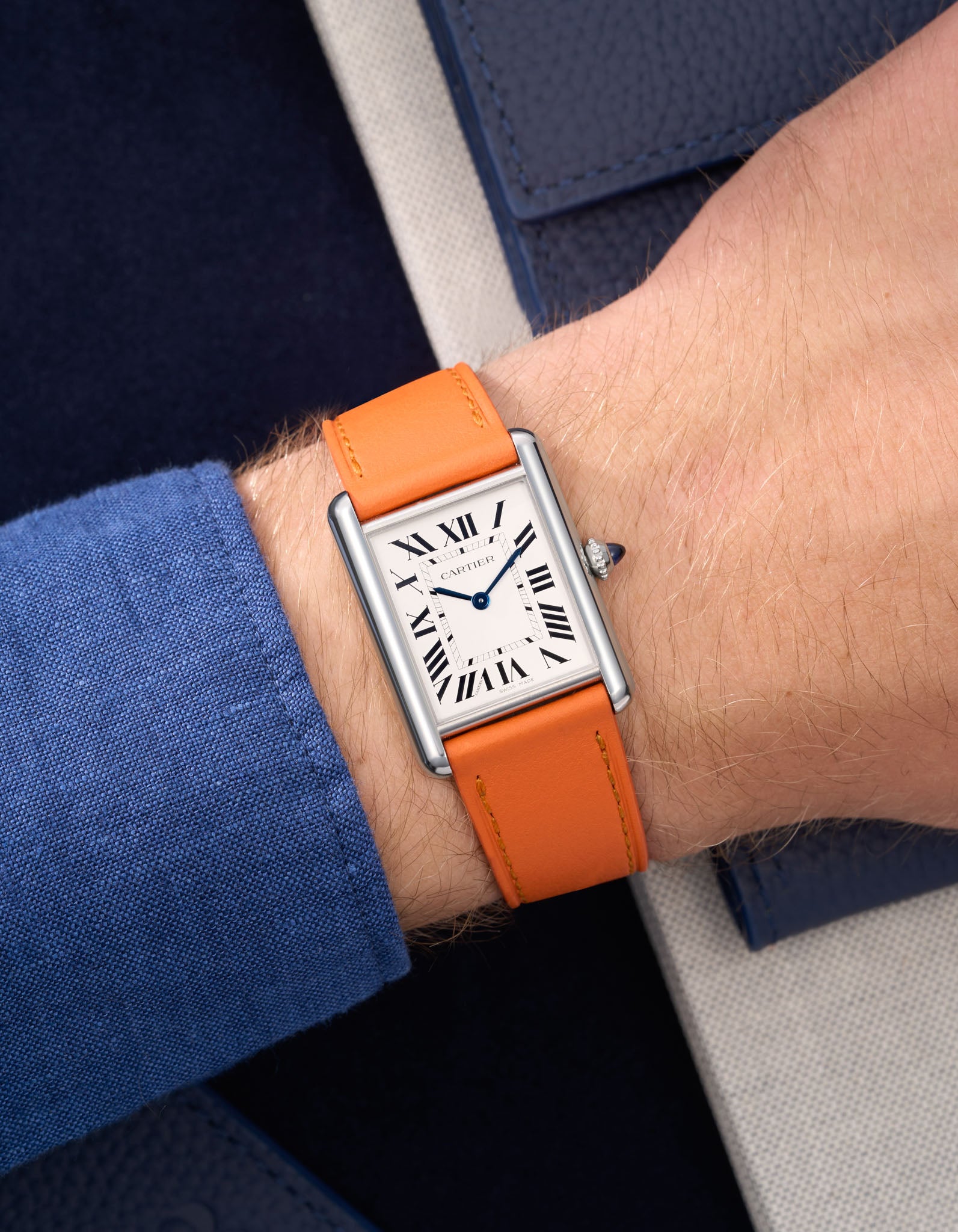 Orange Cowhide Leather Straps for Cartier Tank Must Large wrist shot over blue table