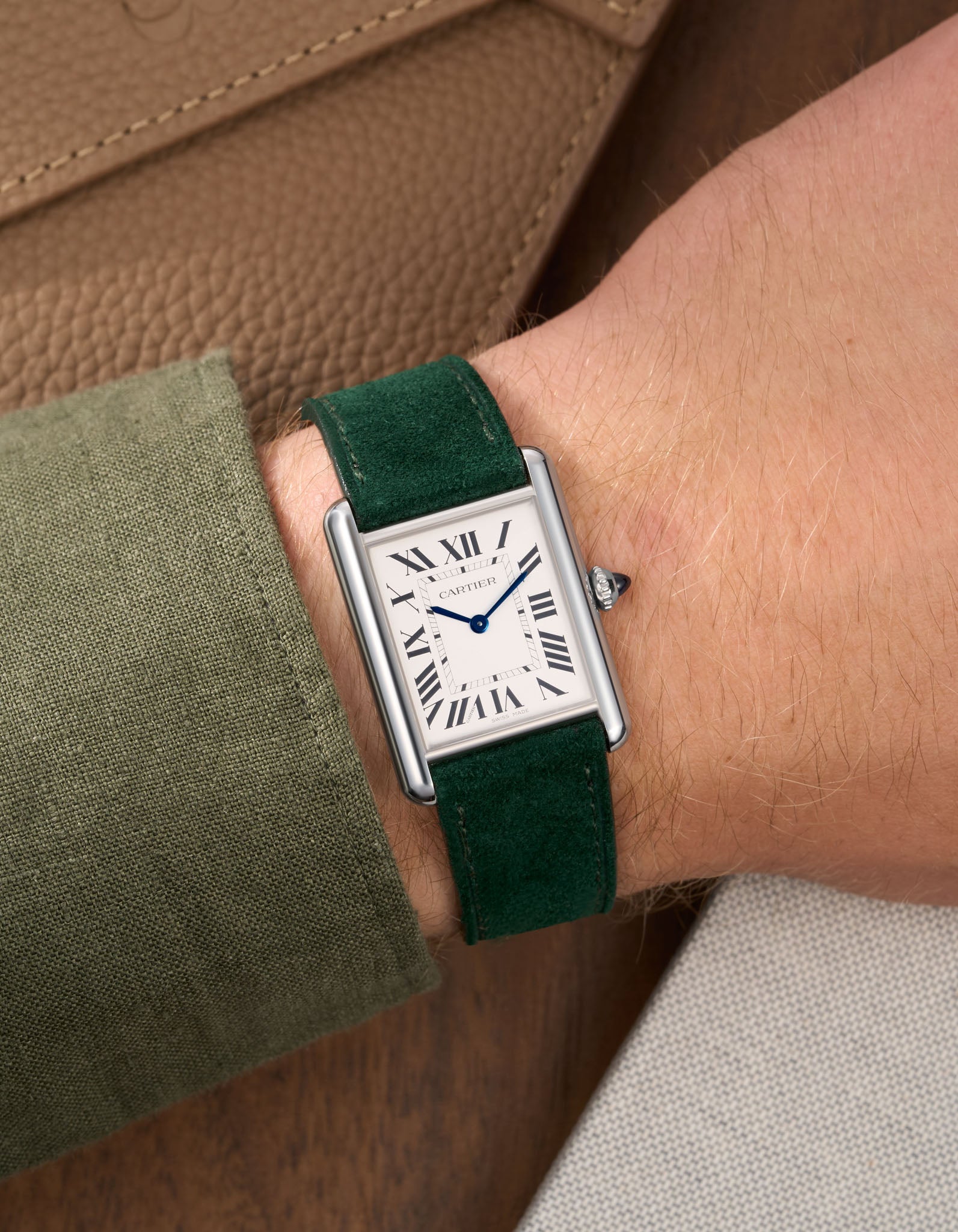 Green Suede Leather Straps for Cartier Tank Must Large wrist shot over brown table