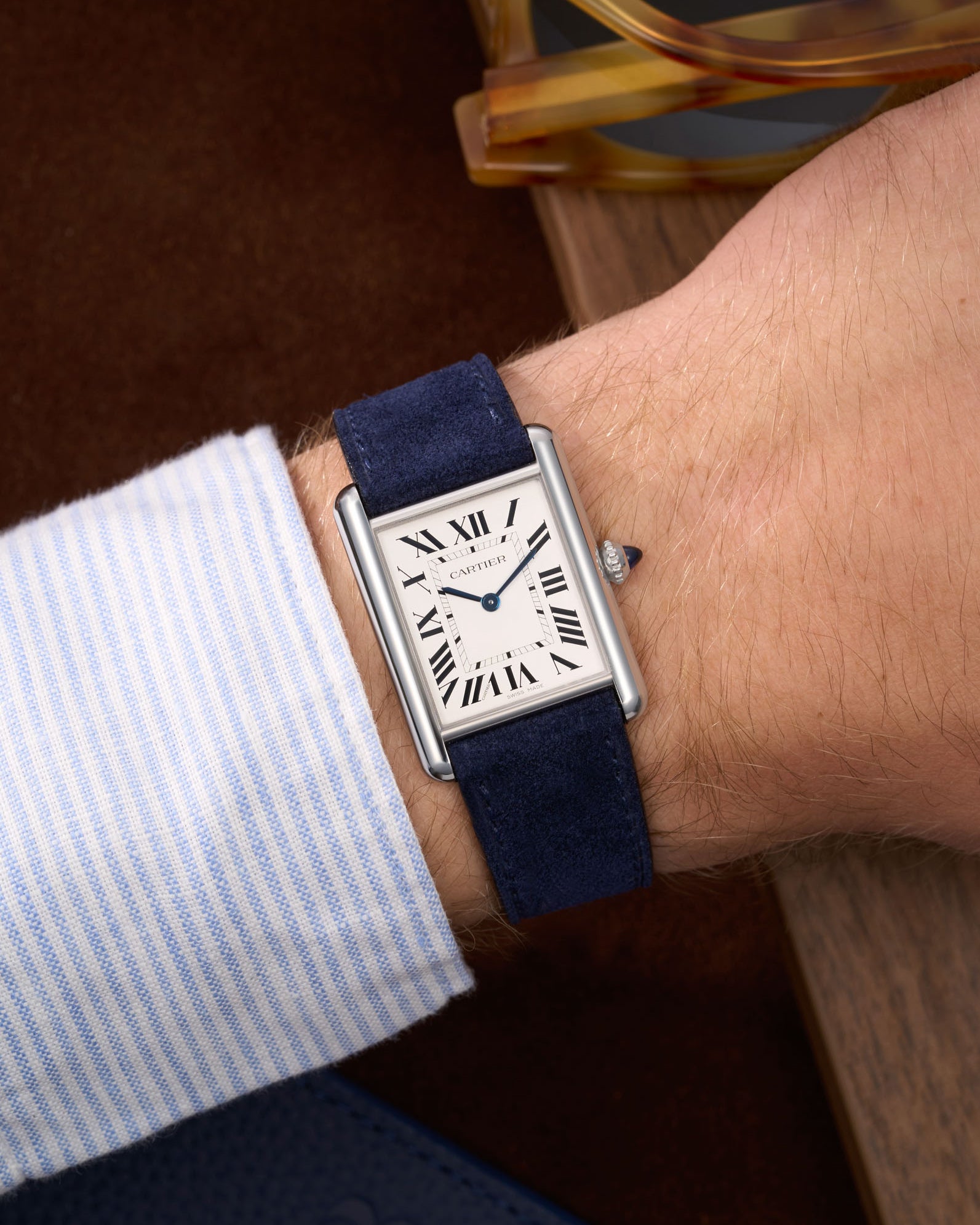 Dark Blue Suede Leather Straps for Cartier Tank Must Large wrist shot over brown table