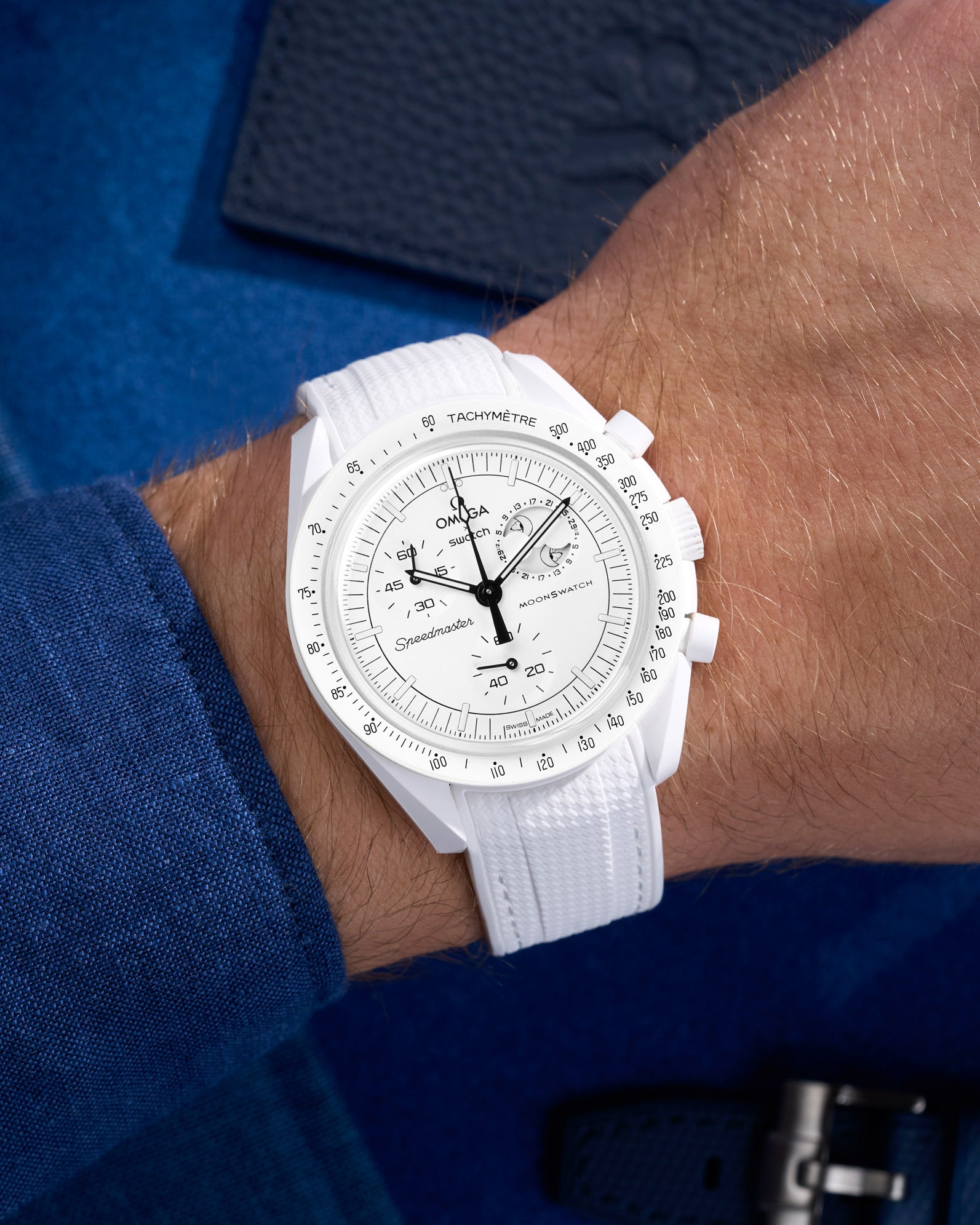 White Vertech rubber strap on Omega Swatch MoonSwatch Mission to the Moonphase shown on wrist with shirt