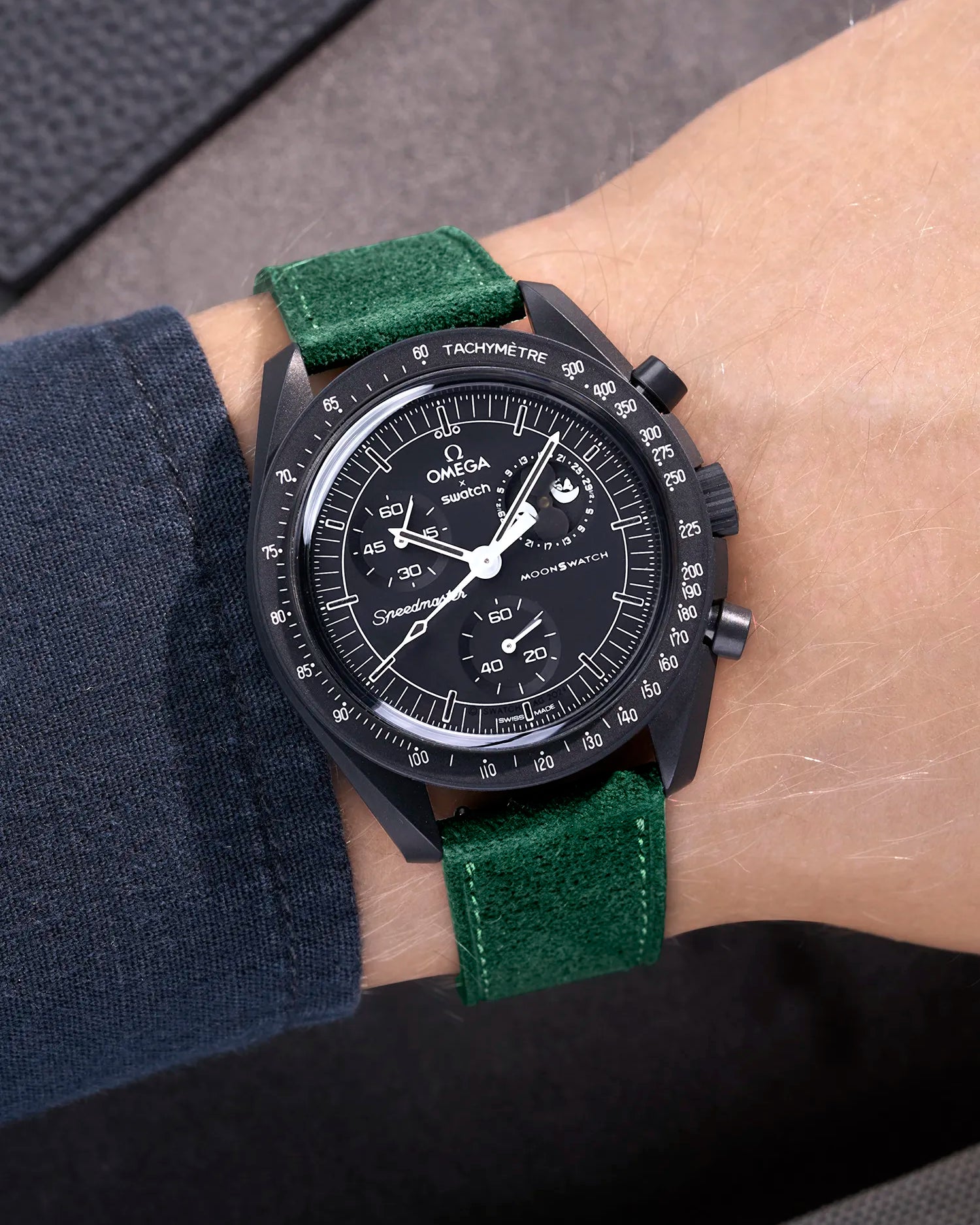 Omega X Swatch Mission to the Moonphase New Moon with dark green suede leather strap worn on wrist