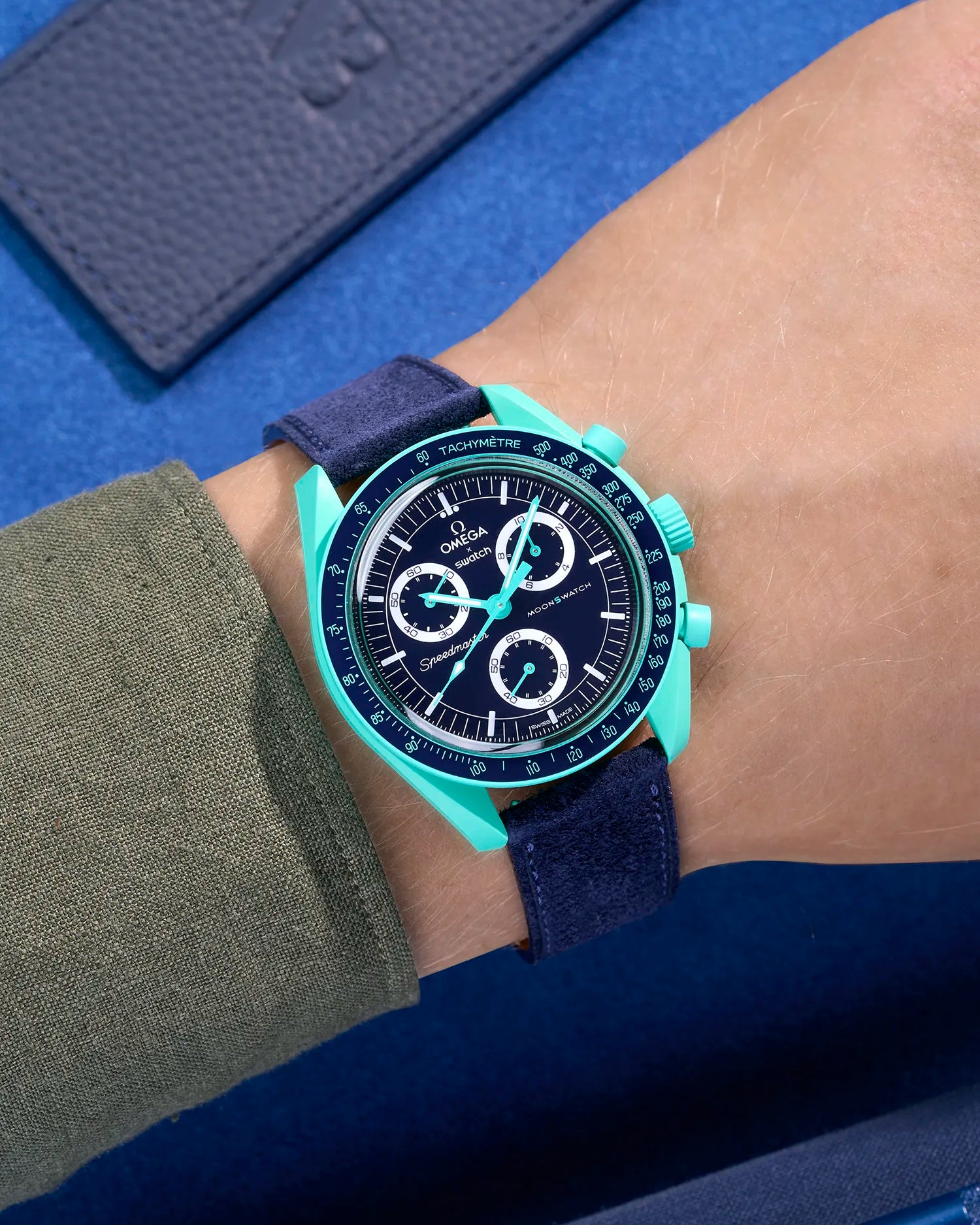 Omega X Swatch Mission on Earth Polar Lights with Dark Blue suede leather strap worn on wrist