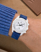 Omega X Swatch Mission to the Moonphase Full Moon with dark blue suede leather strap worn on wrist