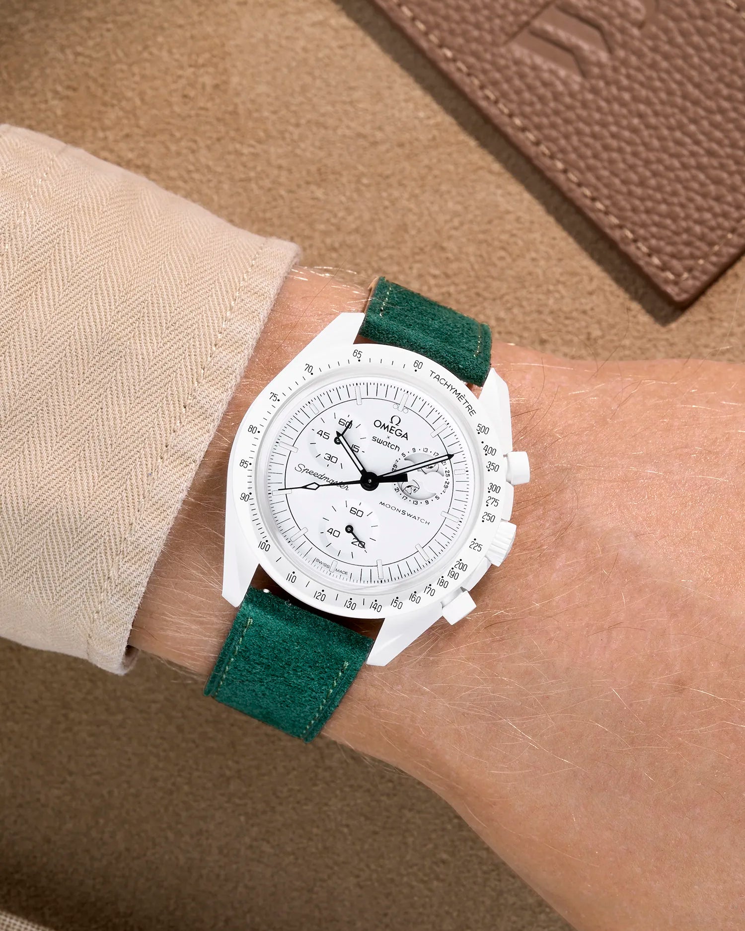 Omega X Swatch Mission to the Moonphase Full Moon with dark green suede leather strap worn on wrist