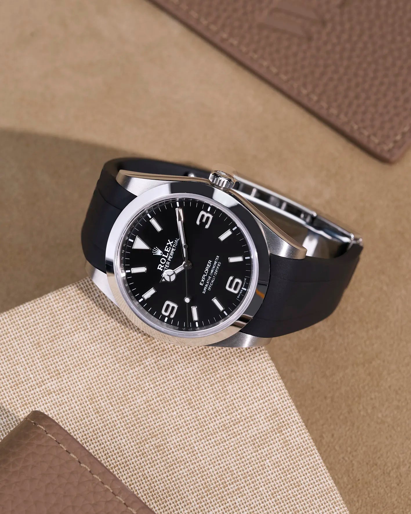Rolex Explorer 214270 on integrated black FKM rubber strap with original clasp – flat lay view