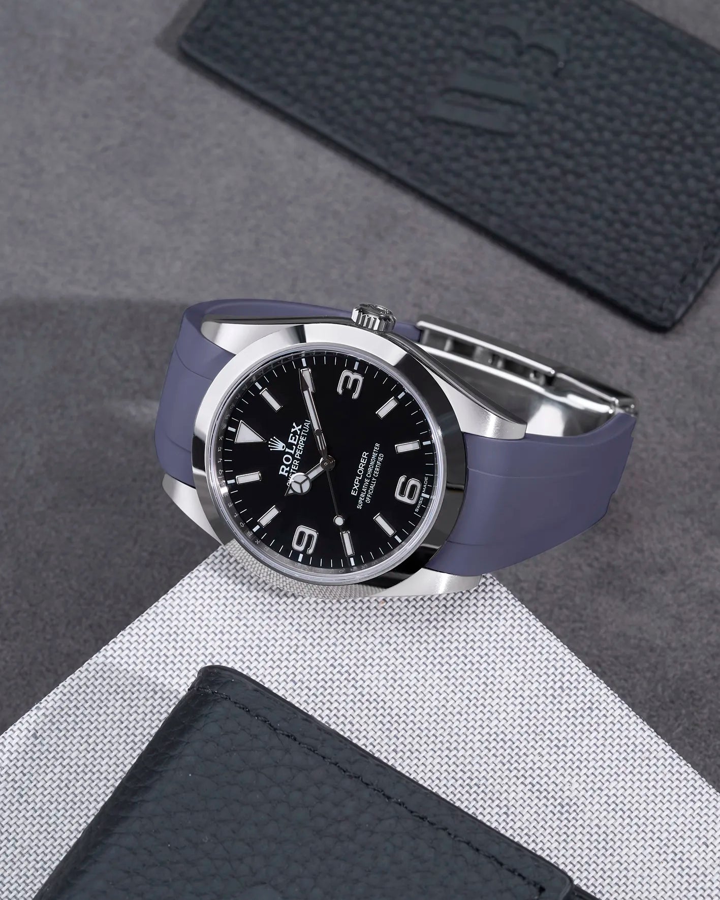 Rolex Explorer 214270 on grey FKM rubber strap integrated with original clasp – angled flat lay