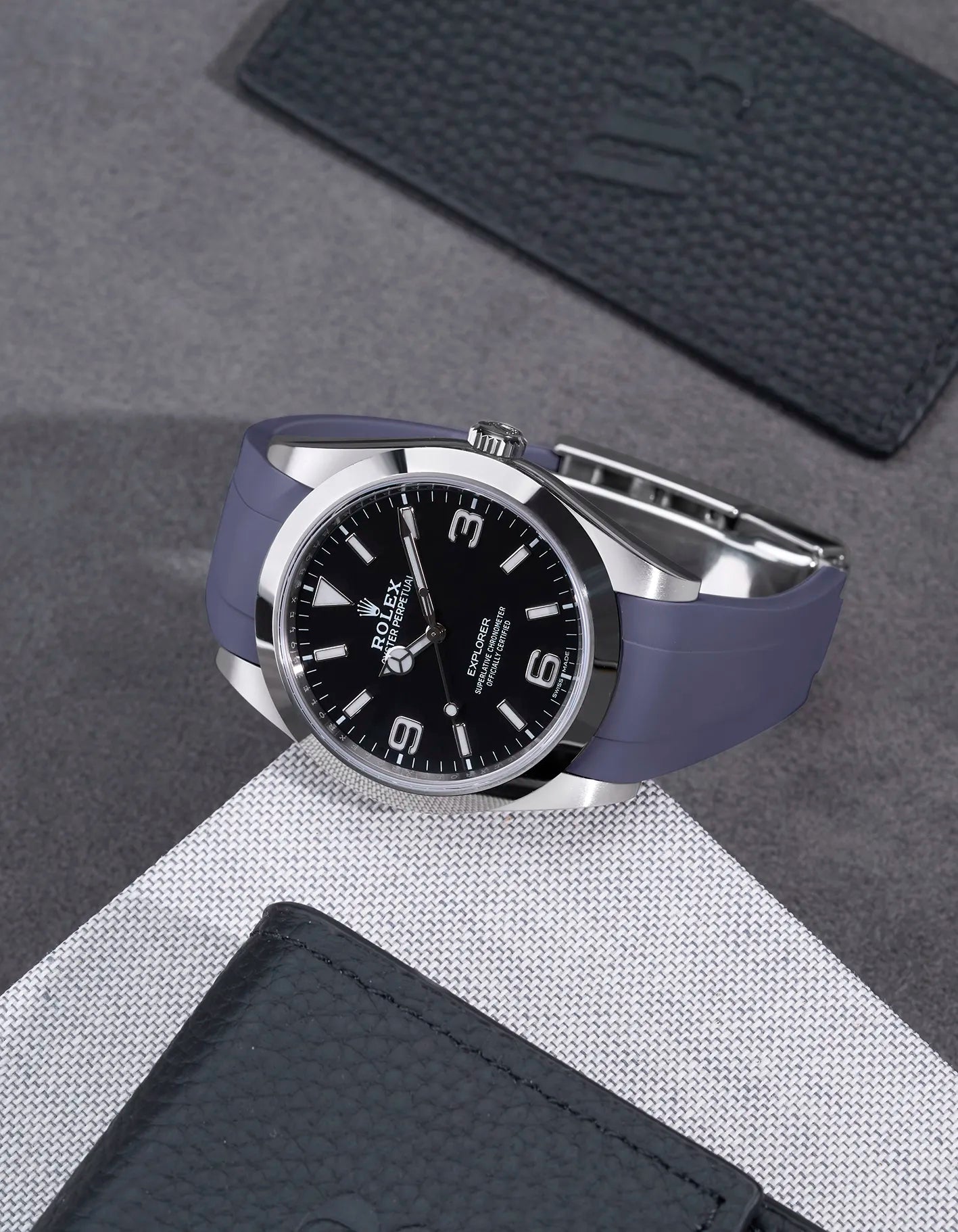 Rolex Explorer 214270 on grey FKM rubber strap integrated with original clasp – angled flat lay
