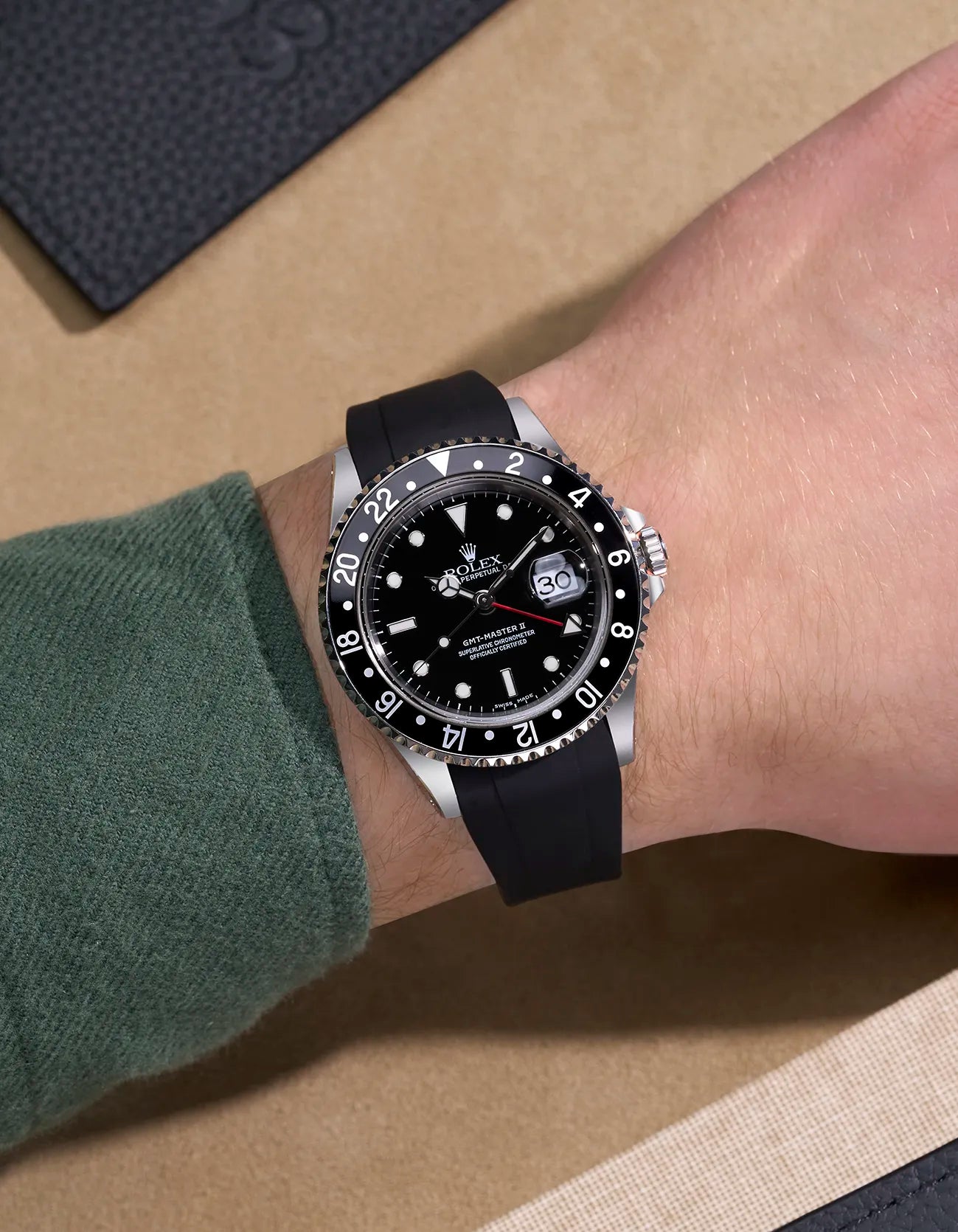 Wrist shot of Rolex GMT-Master II 16710 and 16713 with black rubber strap integrated with original Rolex clasp