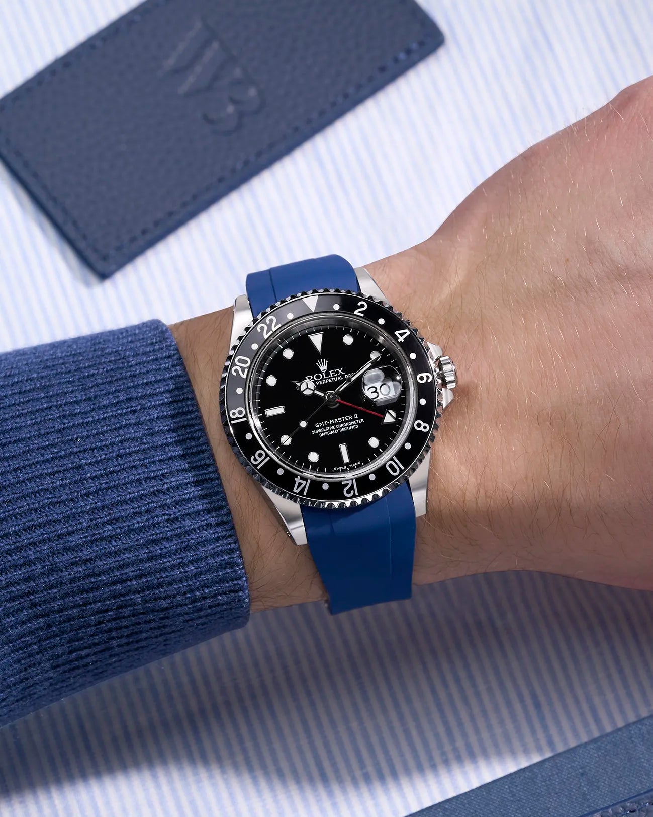 Wrist shot of Rolex GMT-Master II 16710/16713 on blue FKM rubber strap with seamless original clasp integration