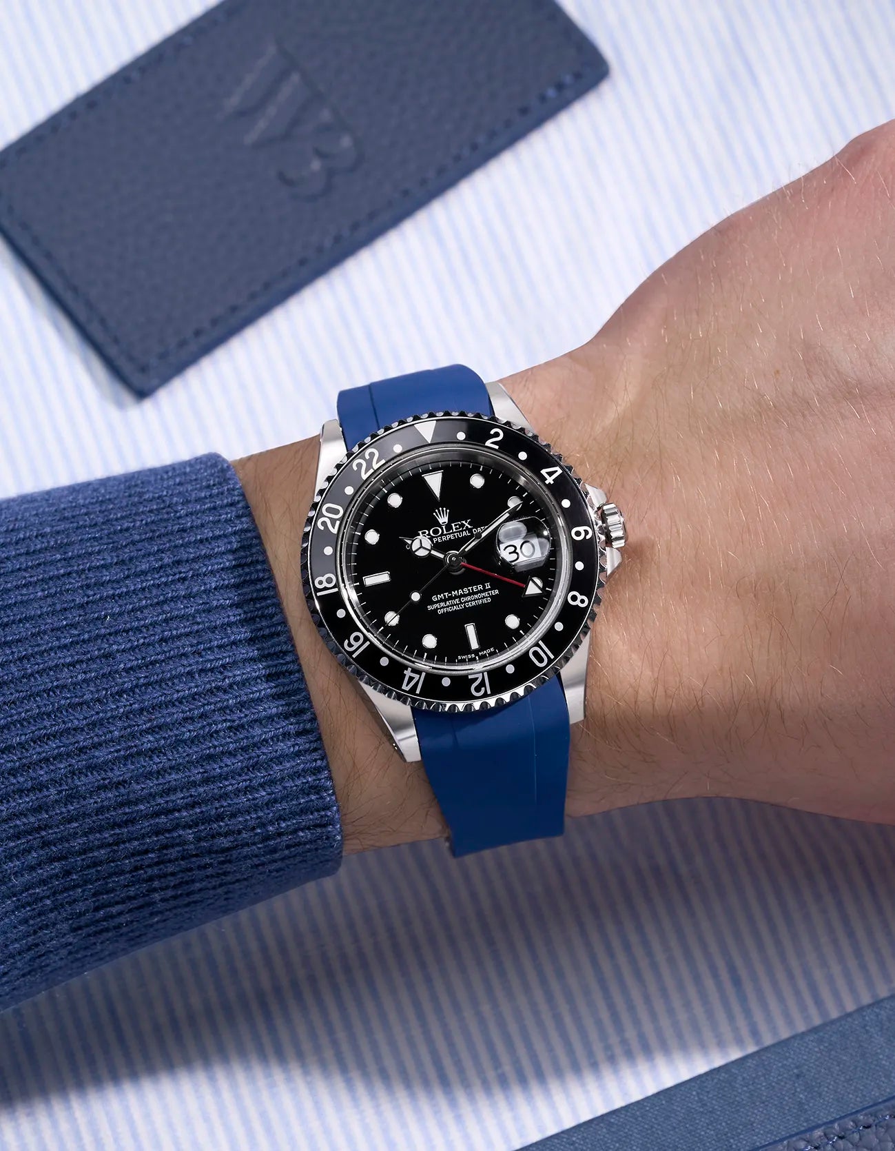 Wrist shot of Rolex GMT-Master II 16710/16713 on blue FKM rubber strap with seamless original clasp integration
