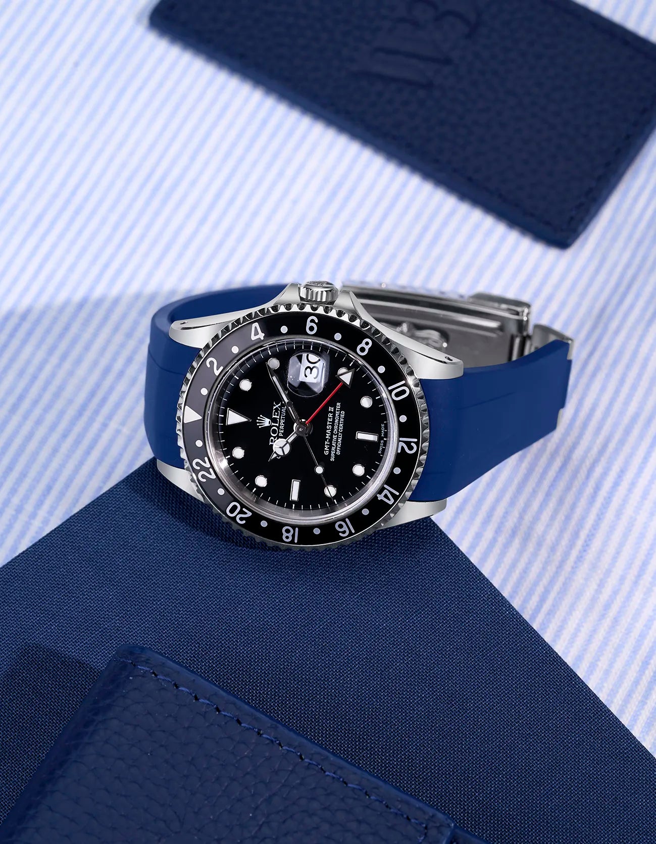 Blue rubber strap fitted on Rolex GMT-Master II 16710 with original clasp – flat lay showcasing seamless integration