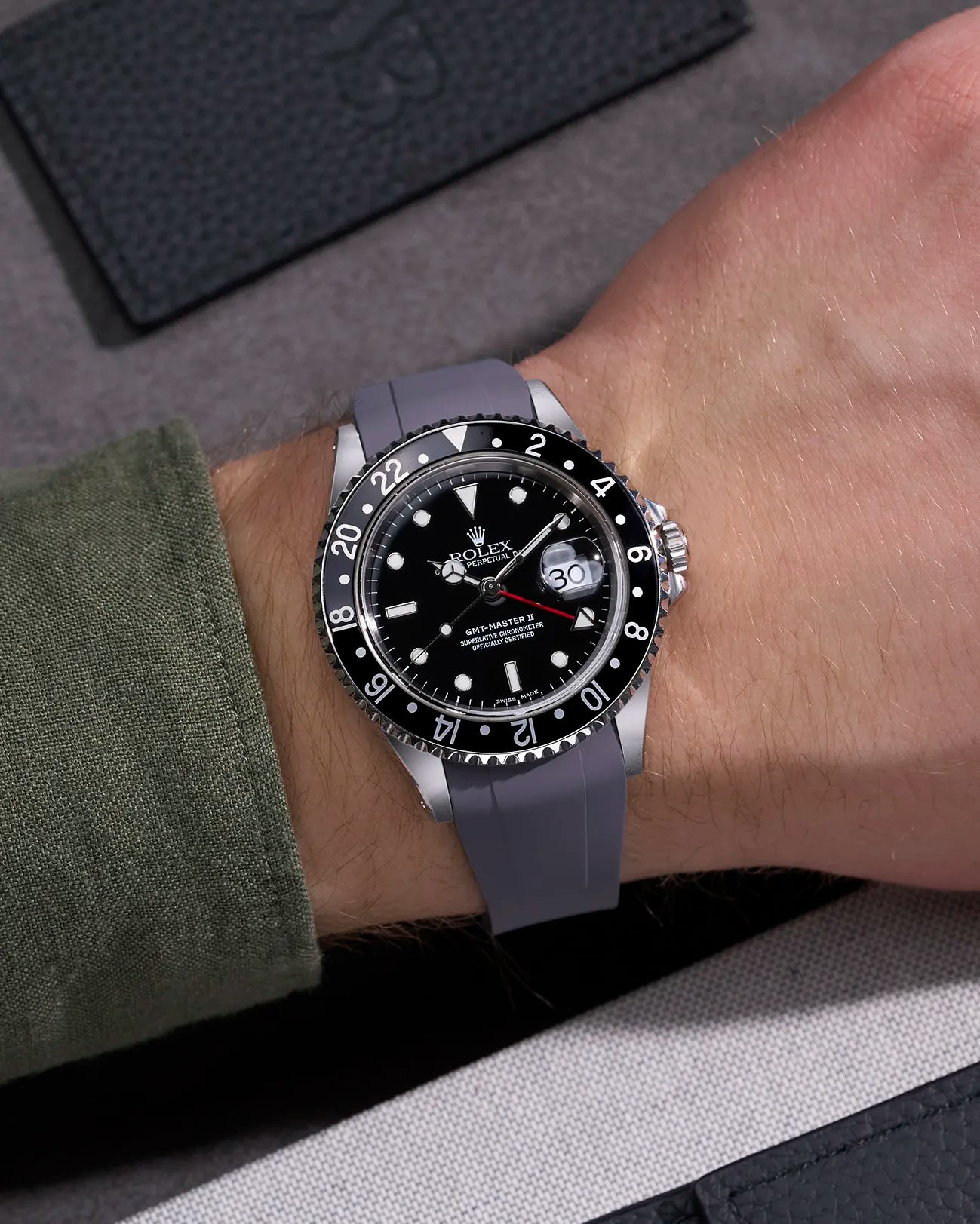 Wrist shot of Rolex GMT-Master II 16710 and 16713 on grey rubber strap integrated with original Rolex clasp