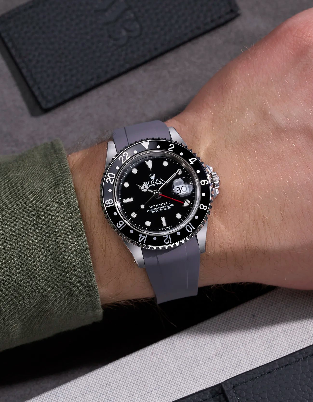 Wrist shot of Rolex GMT-Master II 16710 and 16713 on grey rubber strap integrated with original Rolex clasp
