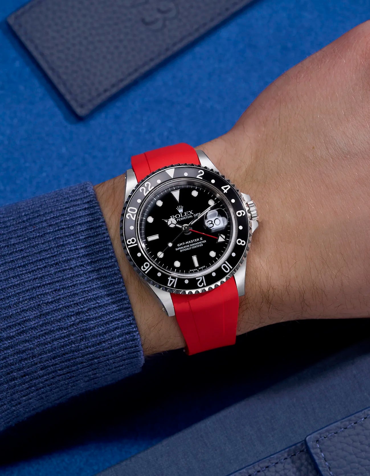 Wrist shot of Rolex GMT-Master II 16710 and 16713 on red rubber strap integrated with original Rolex clasp