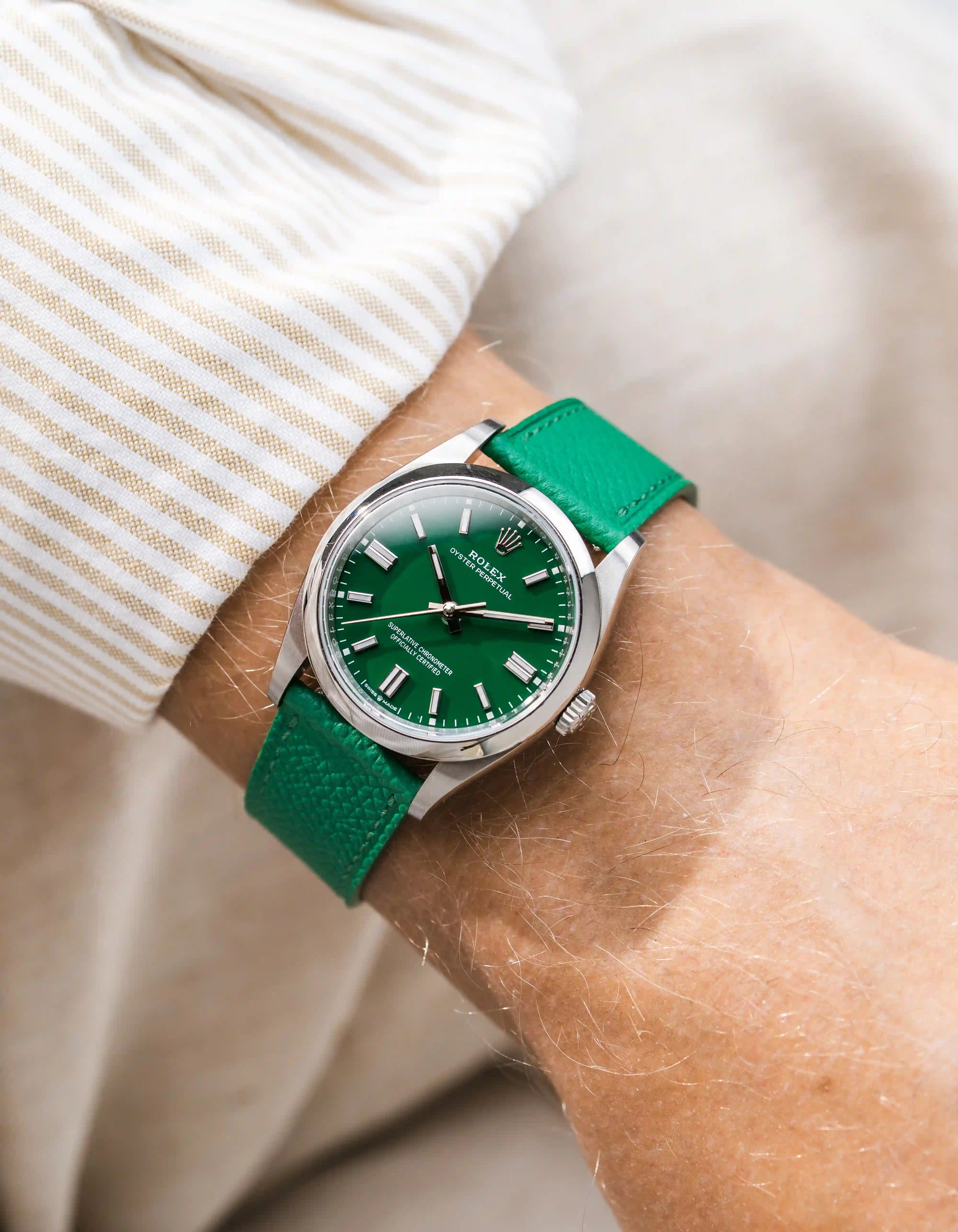 Green Epsom leather straps on Rolex OP wrist shot with beige shirt