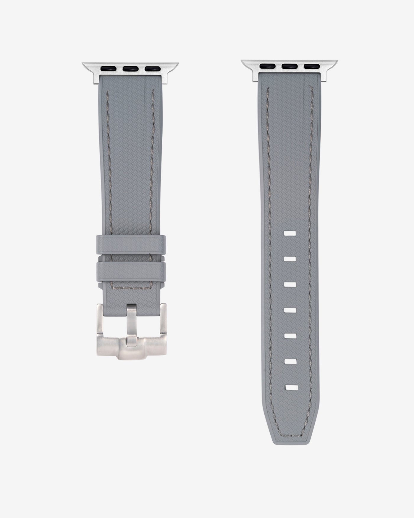 A Grey rubber apple watch band in detail with silver buckle