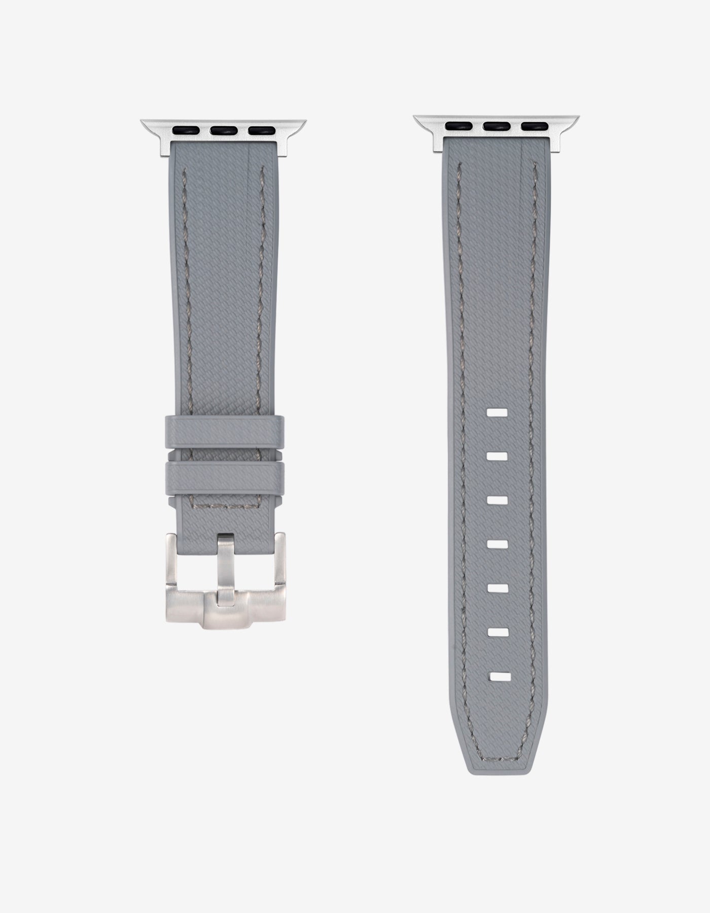 A Grey rubber apple watch band in detail with silver buckle
