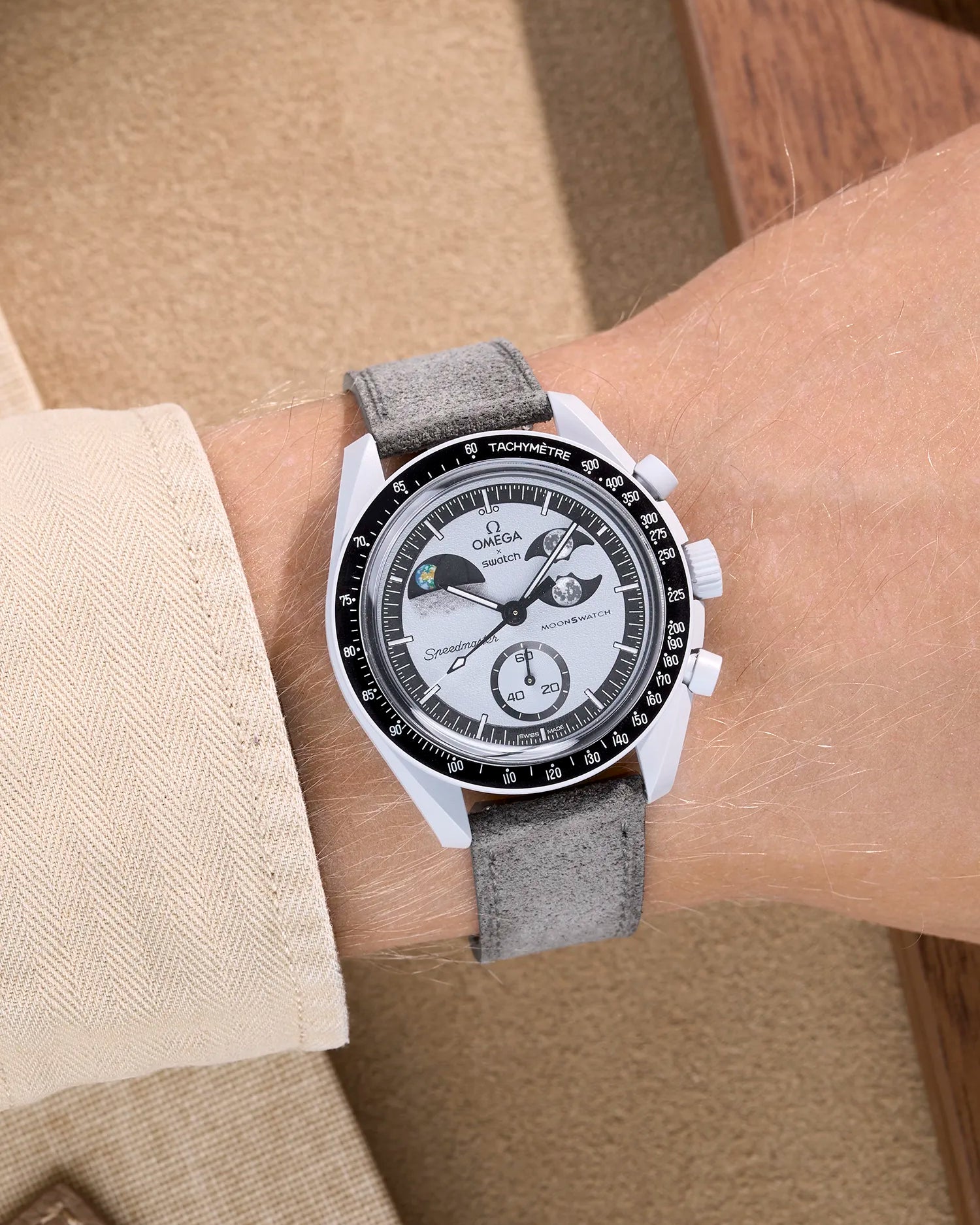 Omega X Swatch Mission to Earthphase with grey suede leather strap worn on wrist