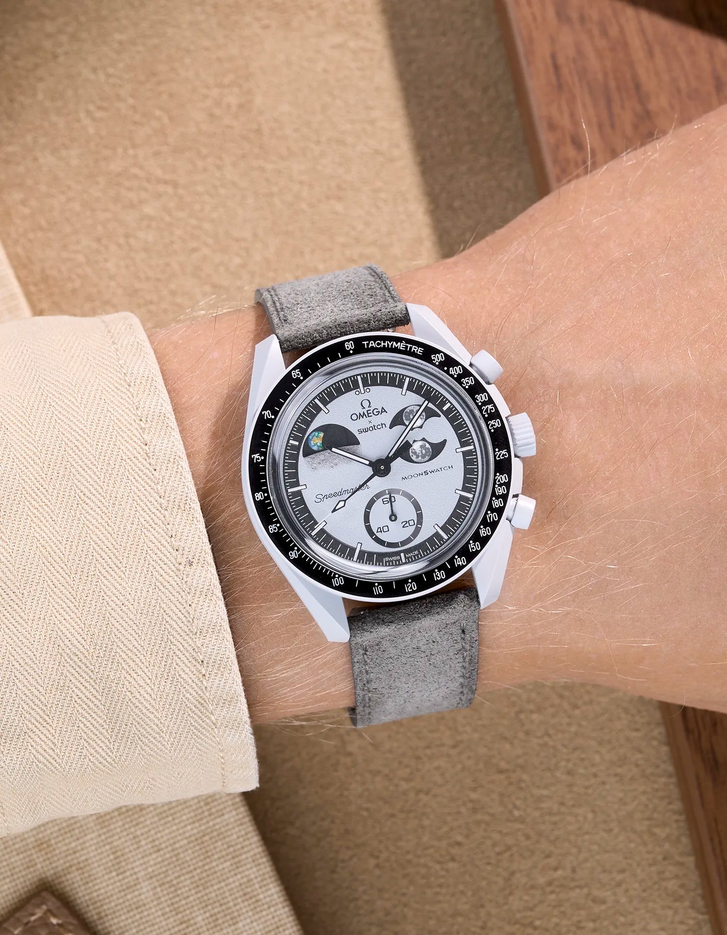 Omega X Swatch Mission to Earthphase with grey suede leather strap worn on wrist