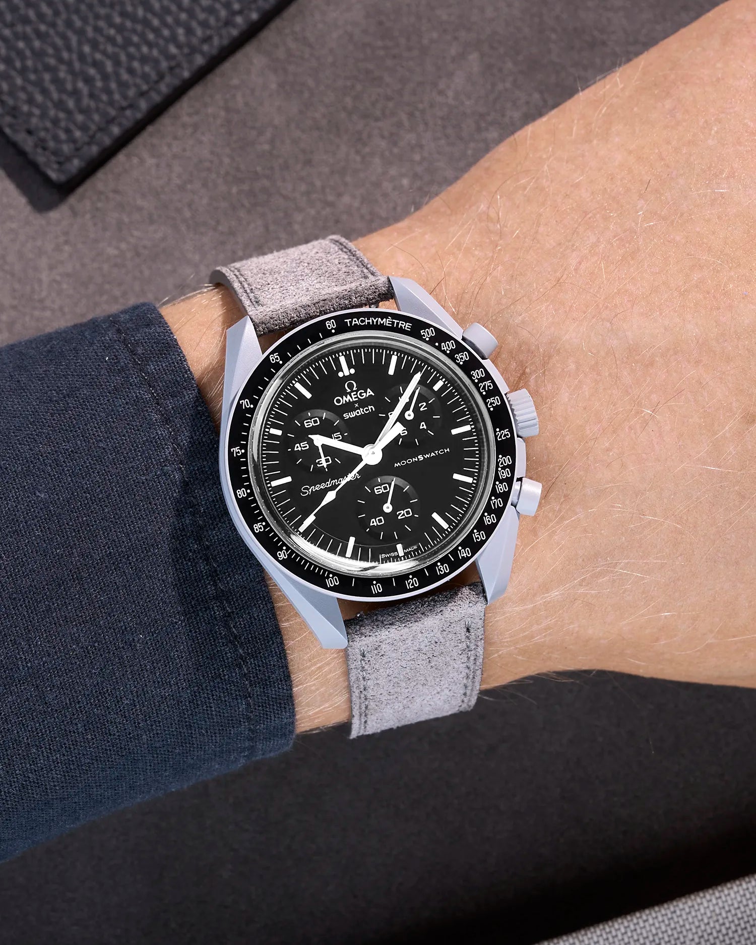 Omega X Swatch Mission to the Moon with grey suede leather strap worn on wrist
