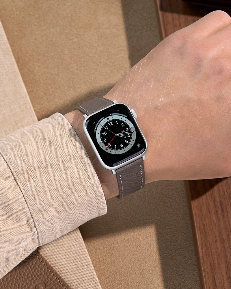 Grey Epsom Leather Apple Watch Band on wrist with beige background