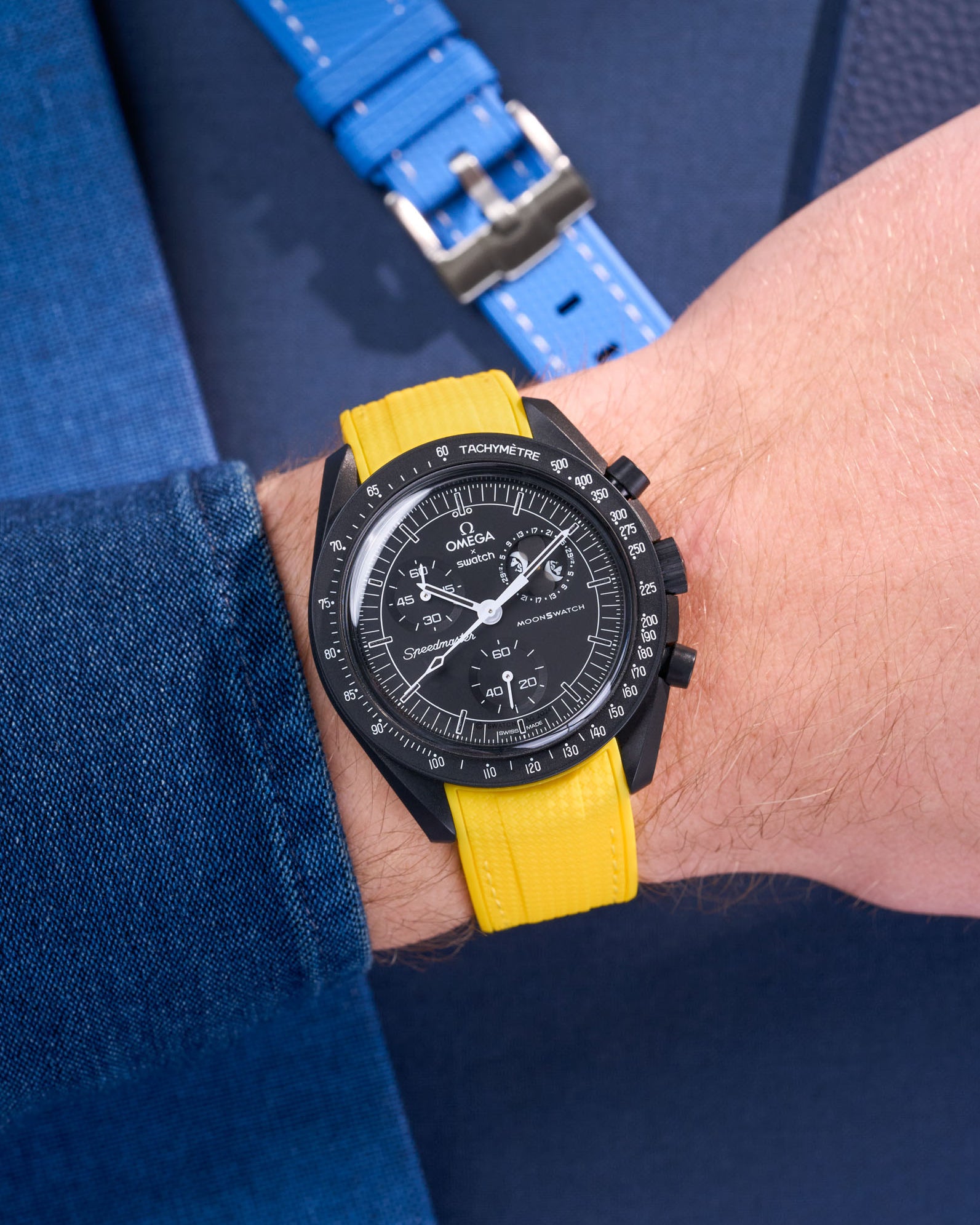 MoonSwatch Mission to Moonphase New Moon on the wrist with vertech yellow rubber strap styled with blue shirt