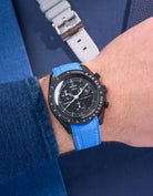 MoonSwatch Mission to Moonphase New Moon on the wrist with vertech neptune blue rubber strap styled with blue shirt