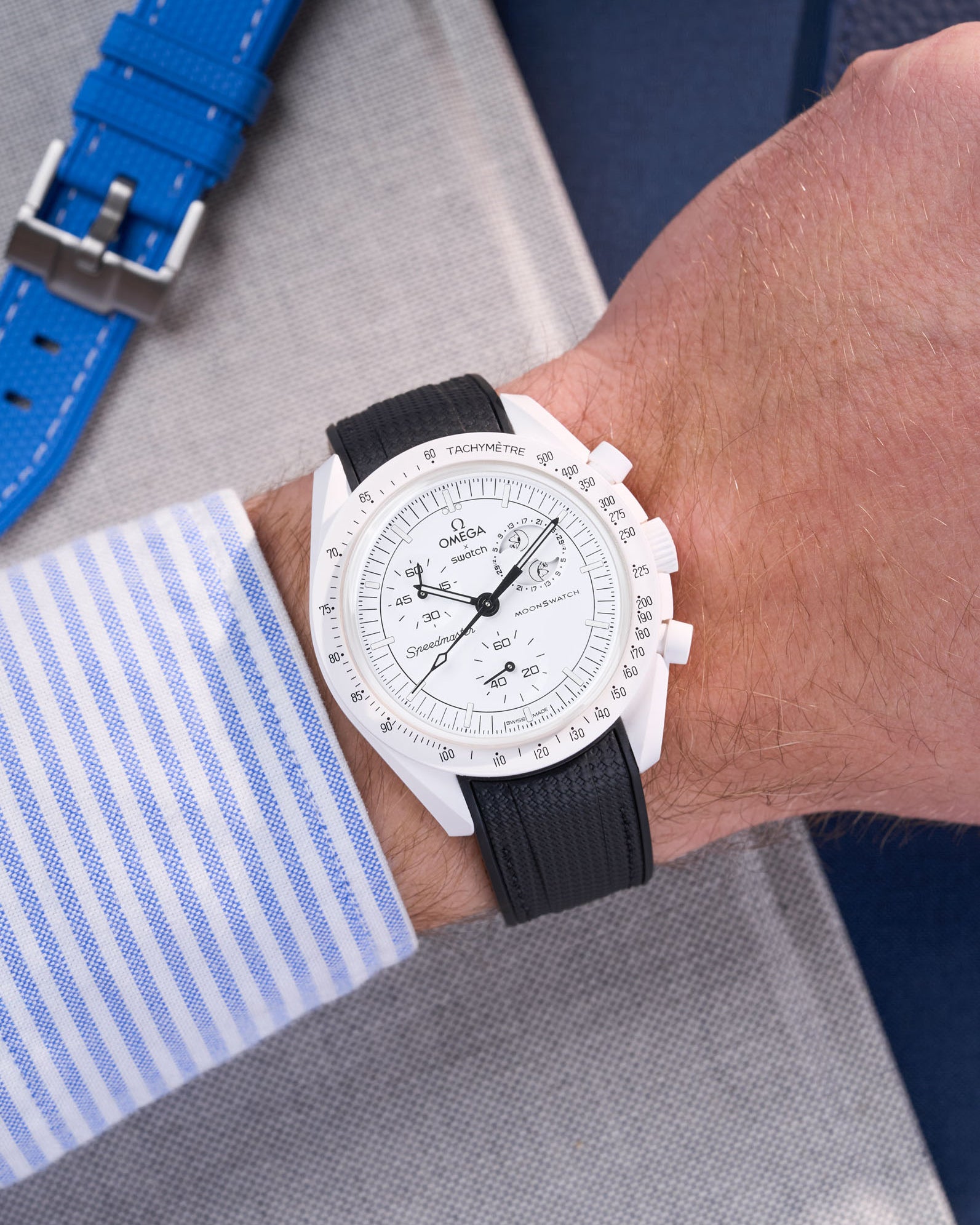 MoonSwatch Mission to the Moonphase with black rubber strap wrist shot styled with striped shirt