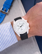 MoonSwatch Mission to the Moonphase with black rubber strap wrist shot styled with striped shirt