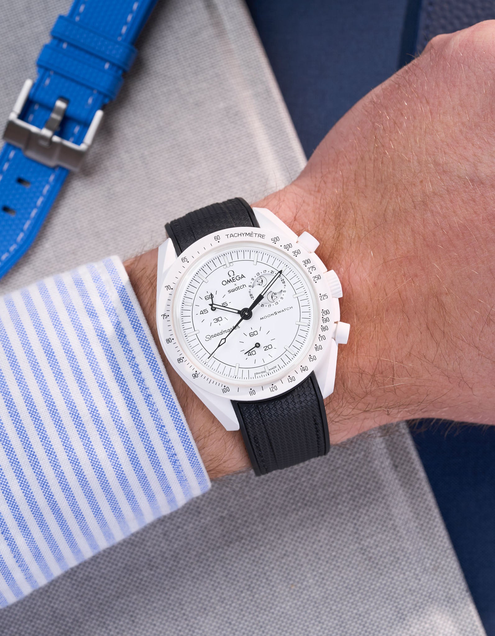 MoonSwatch Mission to the Moonphase with black rubber strap wrist shot styled with striped shirt