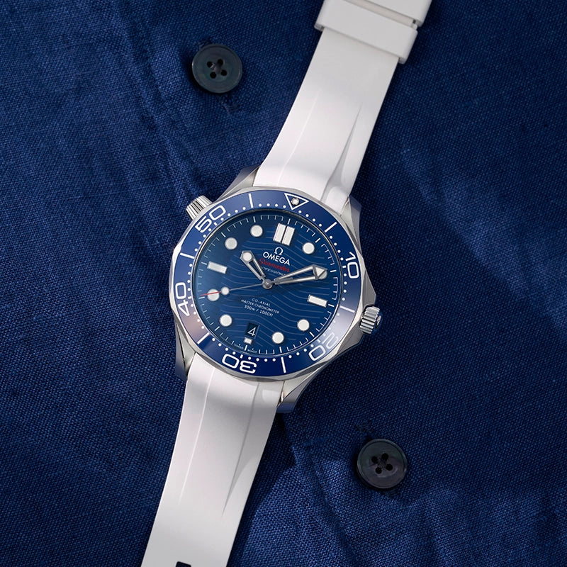 Omega Seamaster 300 Diver watch with white FKM rubber strap placed on blue shirt