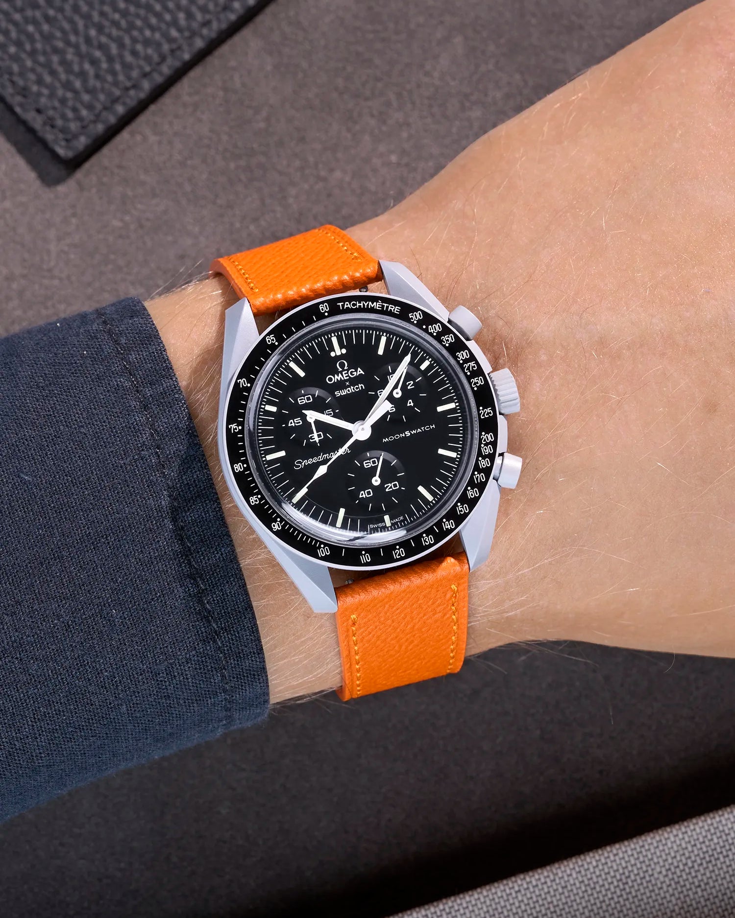 Omega X Swatch Mission to the Moon with orange epsom leather strap worn on wrist