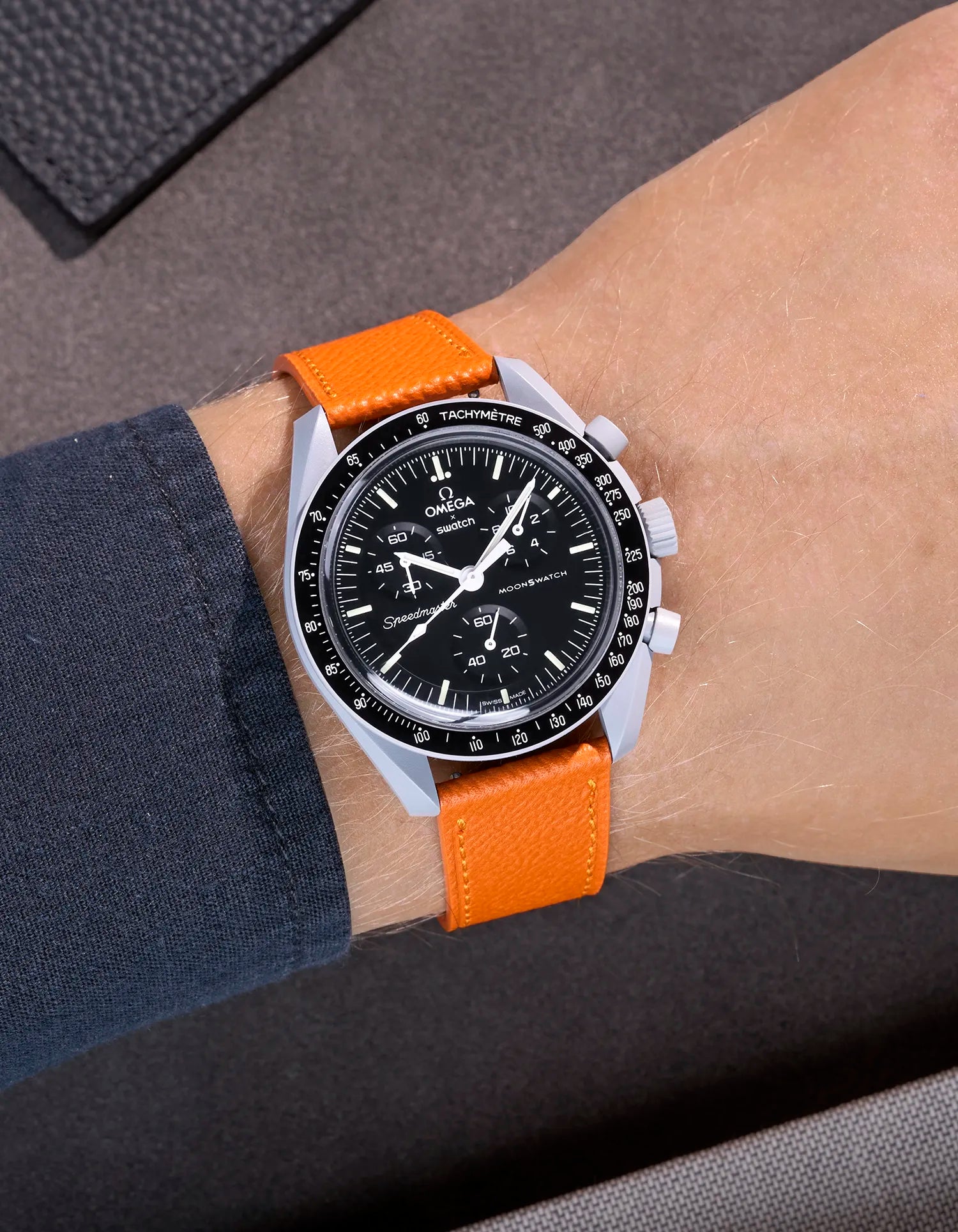 Omega X Swatch Mission to the Moon with orange epsom leather strap worn on wrist