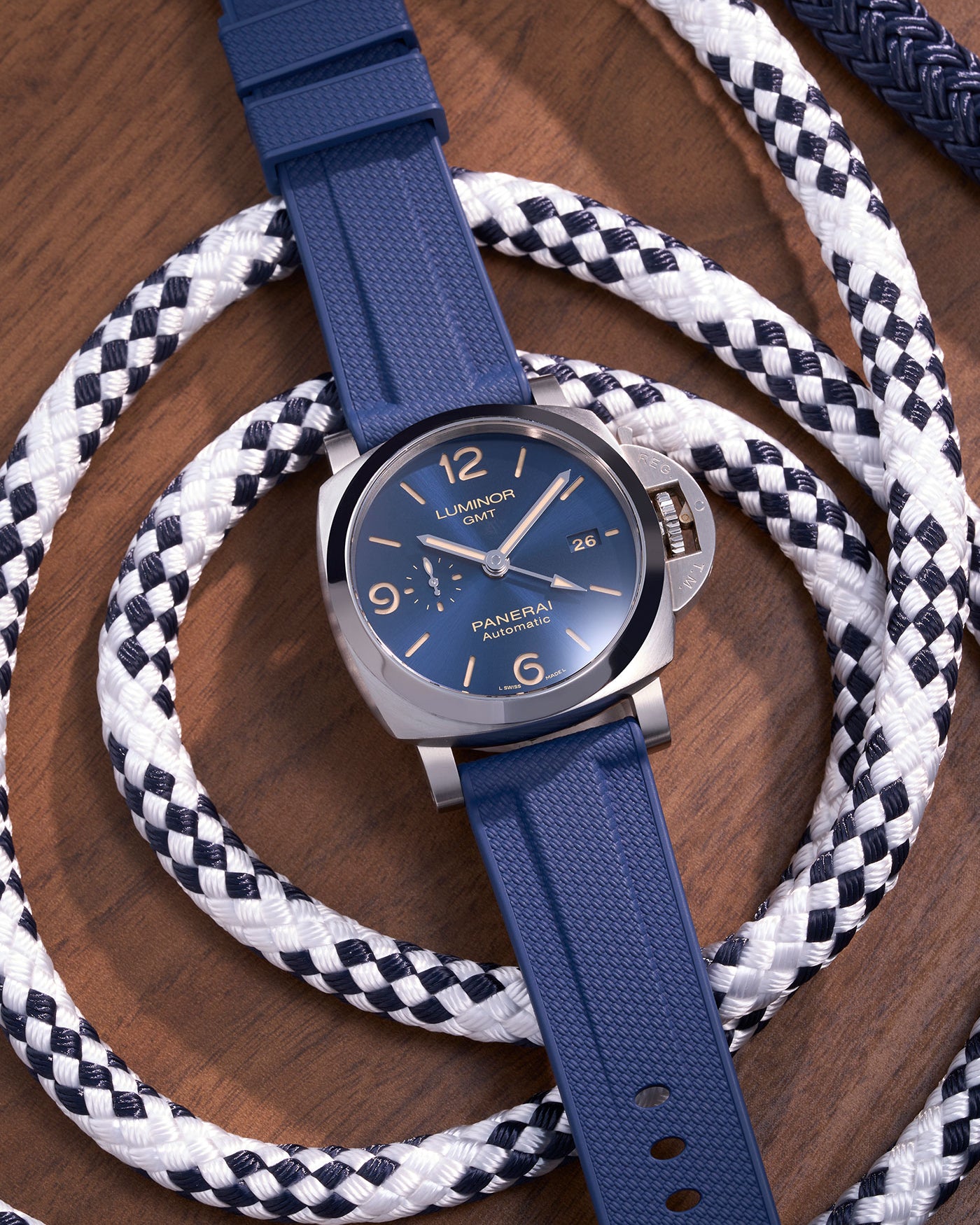 Panerai Luminor GMT Blue Dial with Navy Blue Rubber Strap on Nautical Ropes – Swiss Made luxury watch with iconic Italian design, 44mm polished stainless steel case paired with premium 24mm navy blue rubber uhrenband klockarmband, ideal for maritime and outdoor environments. Perfect for Panerai enthusiasts who value both durability and style, this automatic GMT model combines functionality and elegance, making it suitable for both diving adventures and formal occasions. Panerai klockarmband replacement stra