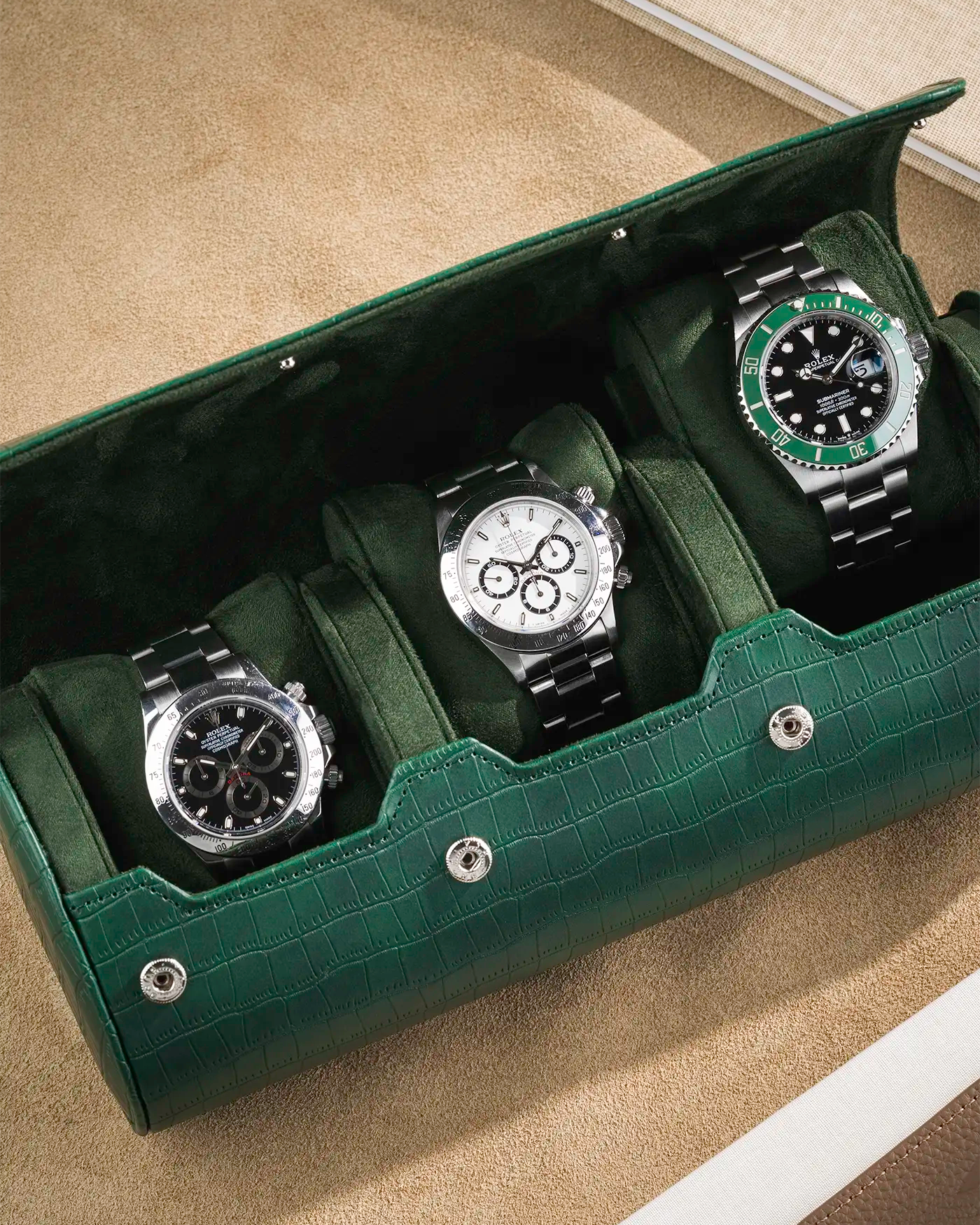 Close up on Green embossed alligator 3 Slot Watch Roll with beige background