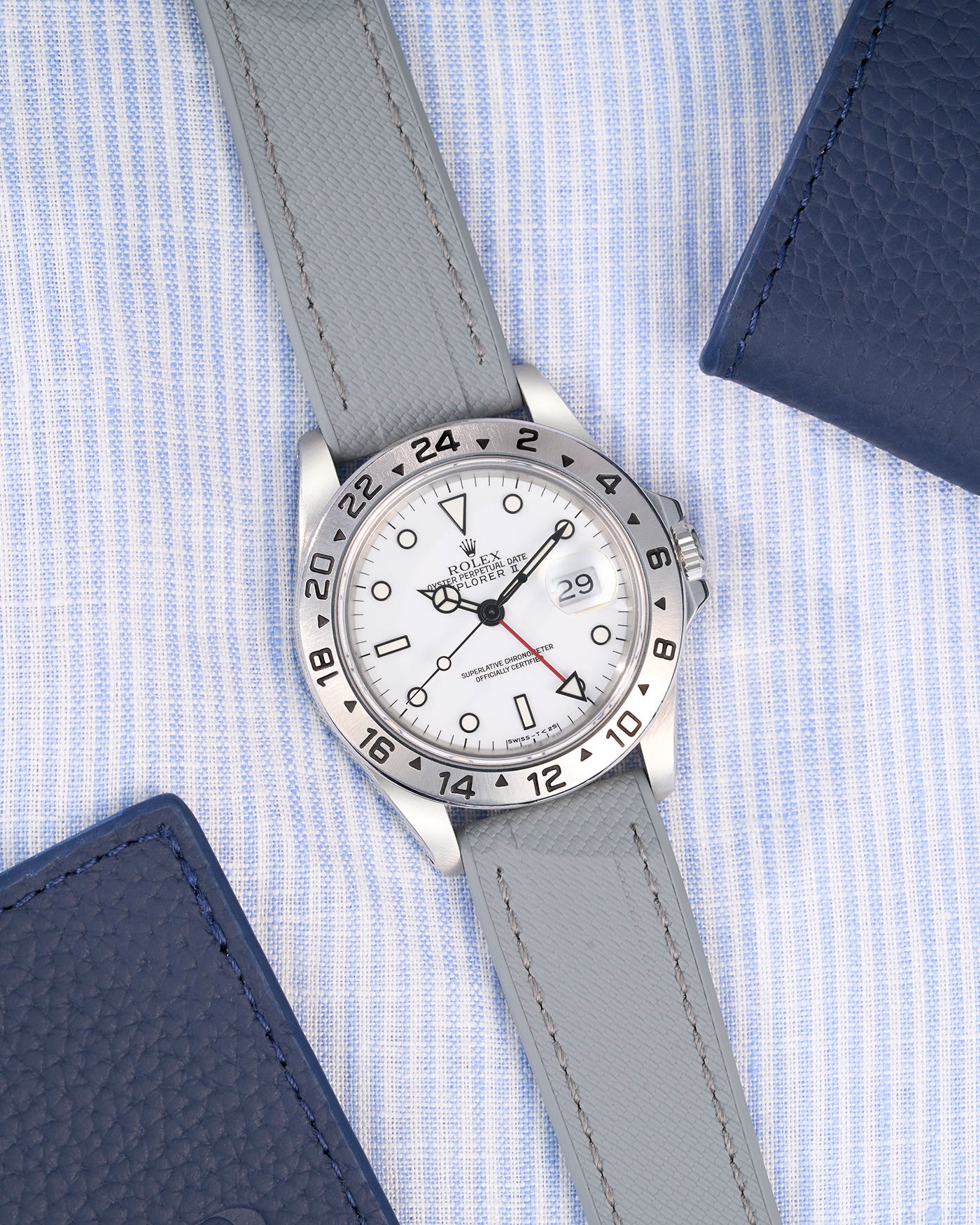 Flat lay of Grey Straight End FKM Rubber Strap 20mm placed on a blue and white shirt