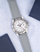 Flat lay of Grey Straight End FKM Rubber Strap 20mm placed on a blue and white shirt